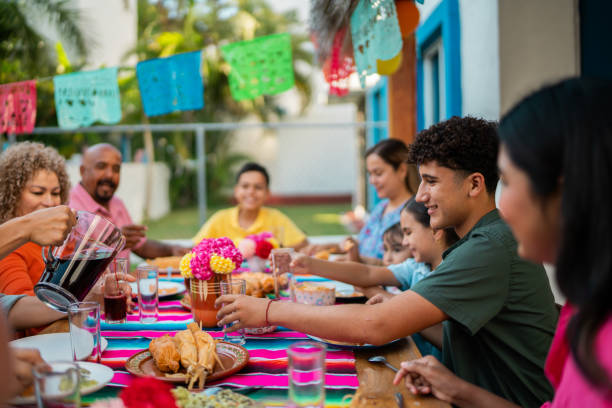 istock Family talking during lunch at house yard 2189075085