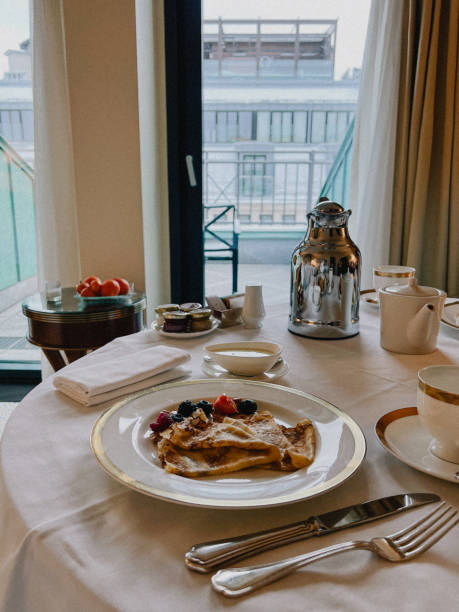 istock Delicious hotel breakfast with crepes, berries, cityscape backdrop 2189076070