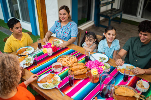 istock Family talking and eating during lunch at house yard 2189076984
