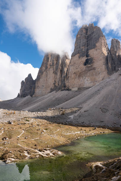 istock Green lake beneath Tre Cime 2189077885