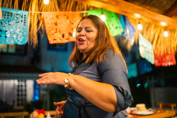Mature woman dancing during party at home