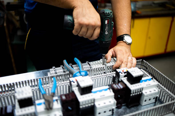 istock Electrician, engineer assembles an electrical cabinet in a factory. 2189078742