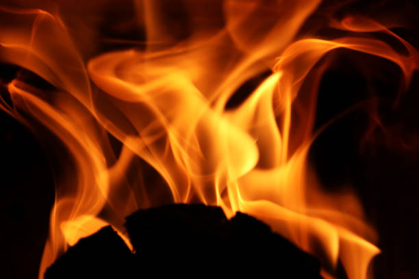 Flames from a fire in front of a black background