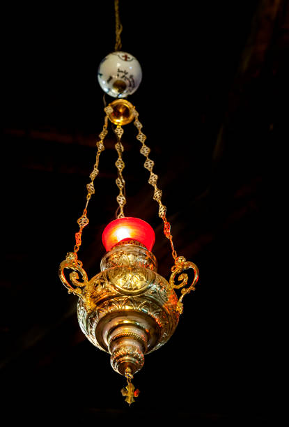 istock Elegant decorative lantern hanging from ceiling with warm red glow 2189082609
