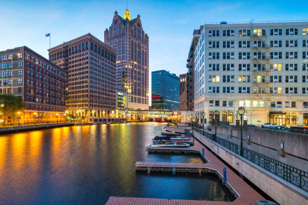 Downtown Milwaukee, Wisconsin, USA with the Milwaukee River and Milwaukee Riverwalk at twilight blue hour.