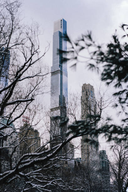 A winter wonderland in Central Park, New York City, featuring snow-covered trees, pathways, and iconic landmarks blanketed in fresh snowfall. This serene and picturesque scene captures the enchanting beauty of Central Park under the snow, perfect for showcasing the charm of winter in an urban setting. Ideal for travel, nature, and seasonal photography enthusiasts.