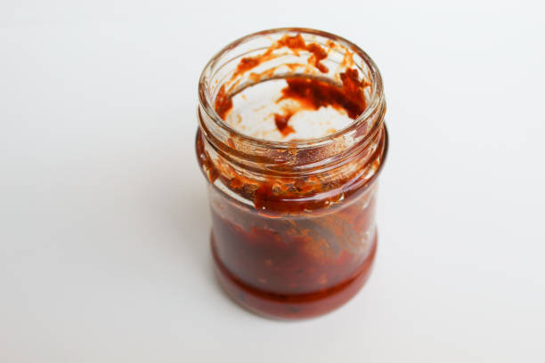 istock Sambal is an Indonesian chilli sauce or paste. In a transparent glass jar. Isolated on white background 2189085157