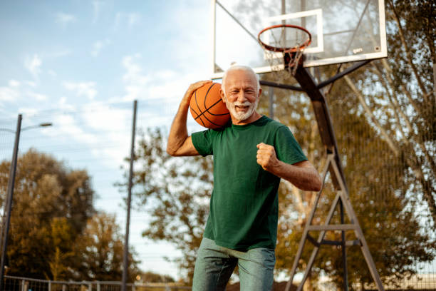 istock Senior Man Having Fun Playing Basketball on a Sunny Day 2189086844