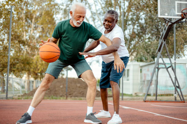 istock Active Senior Duo Playing Basketball on a Sunny Day 2189086870