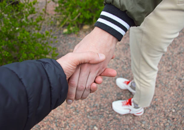 Men is handshake against the background of clouds and the blue sky.
