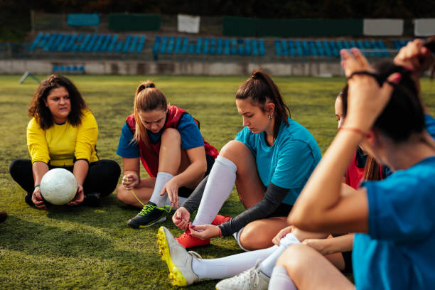 istock Soccer girls adjusting equipment on field. 2189087076