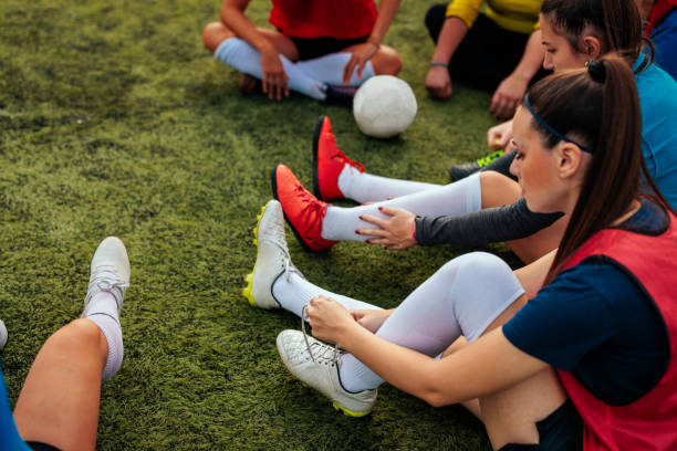 istock Female soccer player tying shoelace. 2189087090