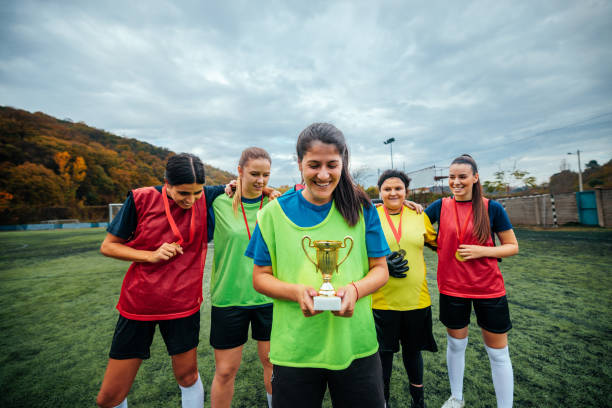 istock Female soccer team captain with trophy. 2189087128