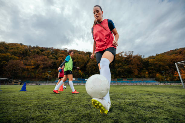 istock Female football player balancing ball. 2189087130