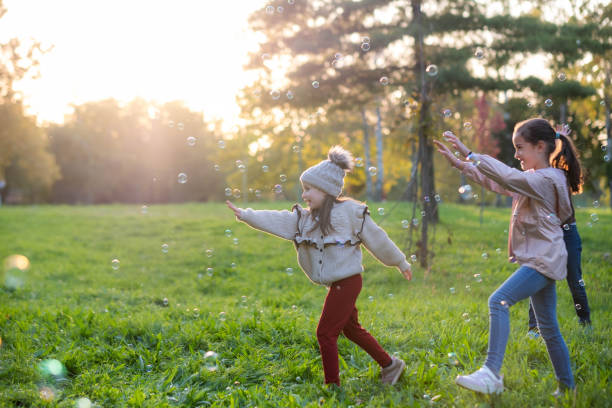 istock happy children play with soap bubbles, chase them, play 2189087209