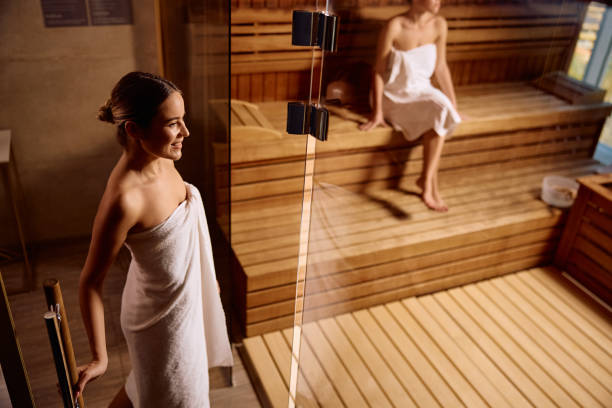 istock Happy woman going into sauna while spending a day at health spa. 2189087273