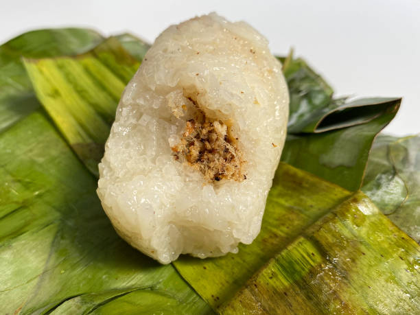 istock Lemper, is a snack made from glutinous rice, filled with meat floss, wrapped in banana leaf 2189087658