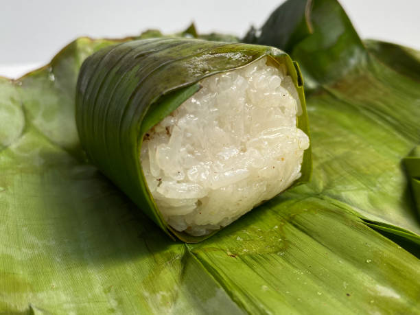istock Lemper, is a snack made from glutinous rice, filled with chicken, meat or fish floss, wrapped in banana leaf 2189087661