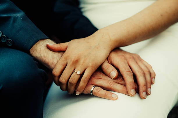 istock Close Up of Married Couple Holding Hands 2189088890