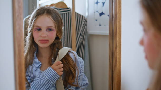 Makeup child mirror reflection at wardrobe closeup. Pretty small girl playing