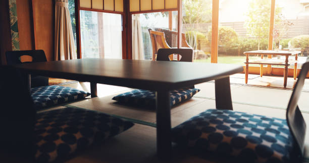 Dining, table and Japanese interior design with floor chair with Asian culture for mindfulness in home. Retro, empty room and minimalist with low wood furniture and mat with creative architecture Dining room, table and Japanese interior design with floor chair with Asian culture for mindfulness in home. Retro, empty room and minimalist with low wood table and mat with creative architecture japanese living room interior in traditional and minimal design stock pictures, royalty-free photos & images