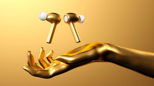 A pair of oversized, golden wireless headphones appear to float in mid-air, supported by a large open hand beneath them. The golden hand is posed as if lifting the headphones, emphasizing elegance, luxury, and innovation. The composition highlights the premium design and futuristic appeal of the headphones in a conceptual 3D setting.