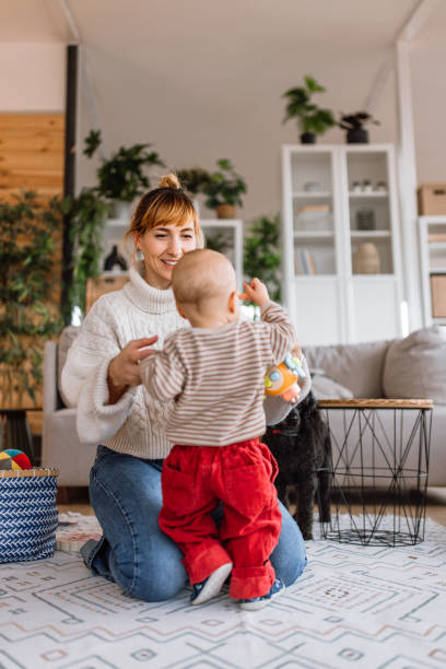 istock Mother helping to her son learn to walk at home 2189093752