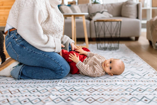 istock Mother is playing with her cute baby son at floor 2189093763