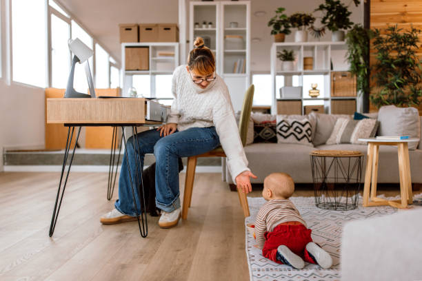 istock Multitasking mother working and taking care of her baby 2189093814