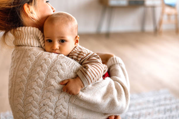 istock Mother holding cute little baby boy 2189093845