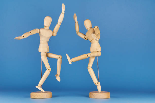 Wooden figure representing various dance movements demonstrating joy and ease