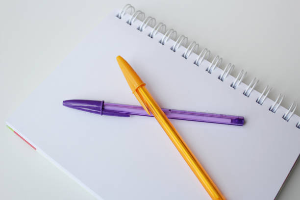 istock Blank paper page notepad and two color pens on white background. 2189094139