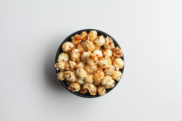 istock Caramel popcorn, in a black bowl, isolated on white background, flat lay or top view 2189095578