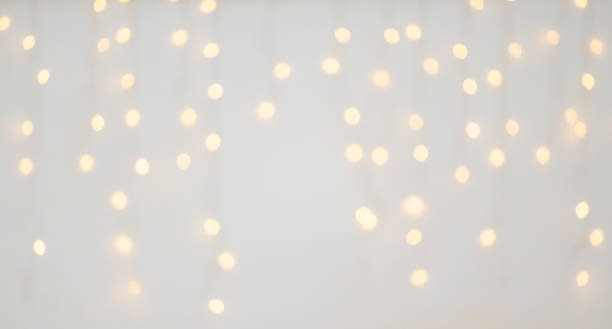 istock Christmas light decoration blurred festive gold bokeh light on white background 2189097968