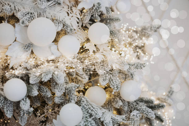 istock Elegant Christmas tree adorned with snowy decorations and white ornaments 2189099534