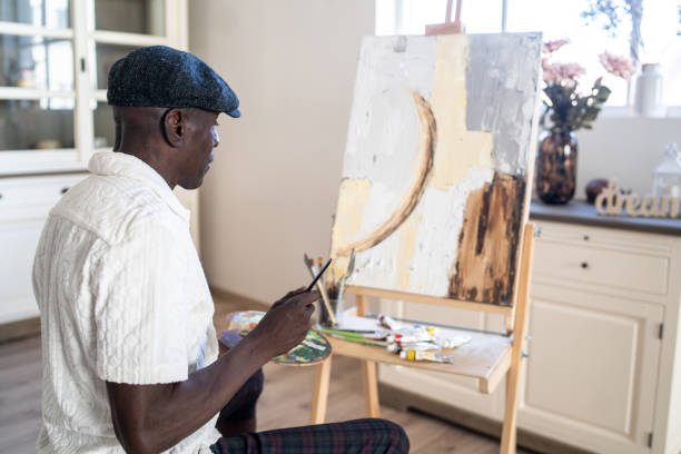 istock Happy retired man painting on canvas for art therapy 2189100304