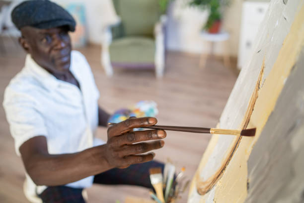 istock Mature man enjoying in painting on canvas at home 2189100314