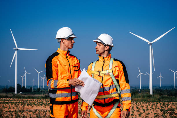 istock Two engineers discussing on the wind turbines farm 2189106747