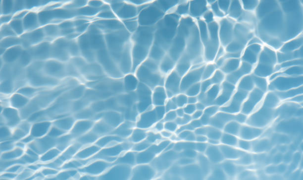 istock Blue water with ripples on the surface. Defocus blurred transparent blue colored clear calm water surface texture with splashes and bubbles. Water waves with shining pattern texture background. 2189109099