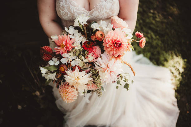 istock Bride holding bouquet of brightly colored flowers 2189109278