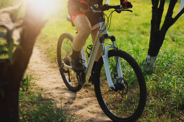 istock Woman biker mountain biking on mountain forest trail 2189109958