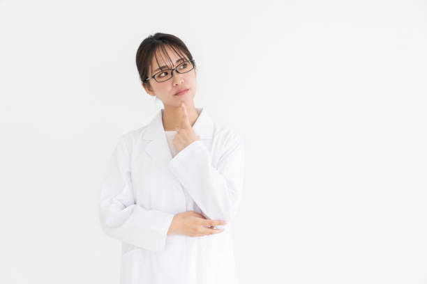 istock attractive asian woman in a white coat, trouble 2189111857
