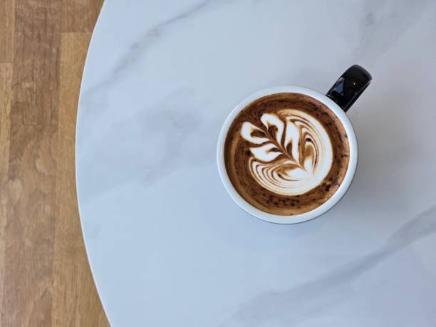 istock Artistic Latte in Black Mug on Wooden Table, Latte art 2189115430