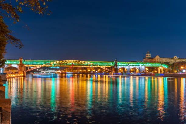 Pushkinskiy bridge with night illumination. Pedestrian bridge with night illumination. Bridge to Gorky Park. Embankment of the Moscow River