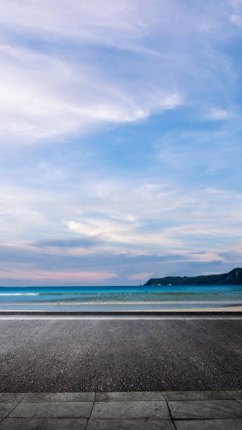 istock Asphalt street with ocean view with blue sky and clouds in the background 2189118041