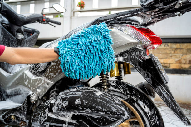 istock Professional worker hand washing the motorcycle with cleaning foam 2189118986