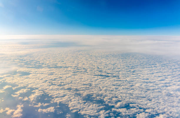 istock View from the airplane window at a beautiful cloudy sky and the airplane wing 2189127540
