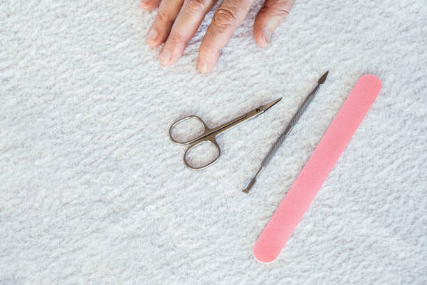 istock Manicure tools and elderly female fingers on a white terry towel, copy space. 2189131585