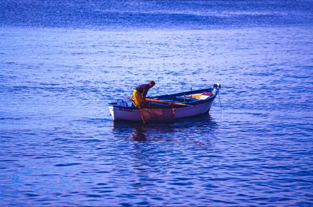 Fisherman on fishing boat arriving at  harbor. Sao Miguel island, Azores, Portugal.