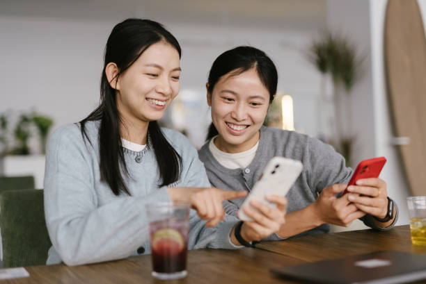 istock Two Asian female white-collar workers were using cell phones in the office 2189138317